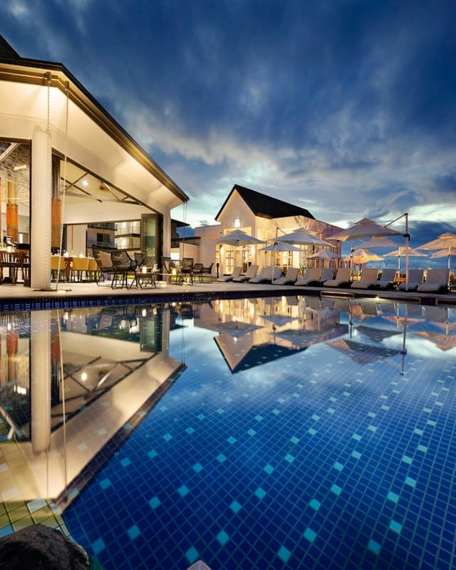 Hotel pool surrounded by a tropical resort