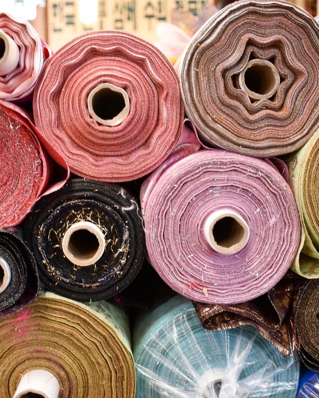 Colorful fabric rolls arranged in a textile workshop